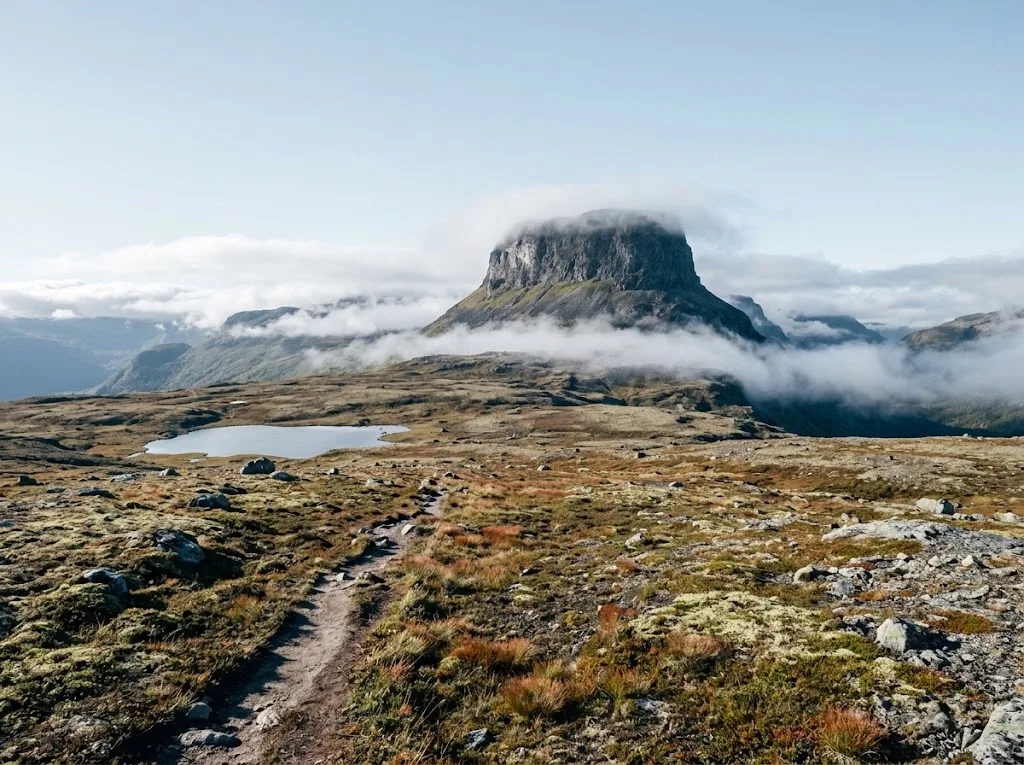 Artist's impression of a flat-topped mountain rising above a high plateau, with a footpath
